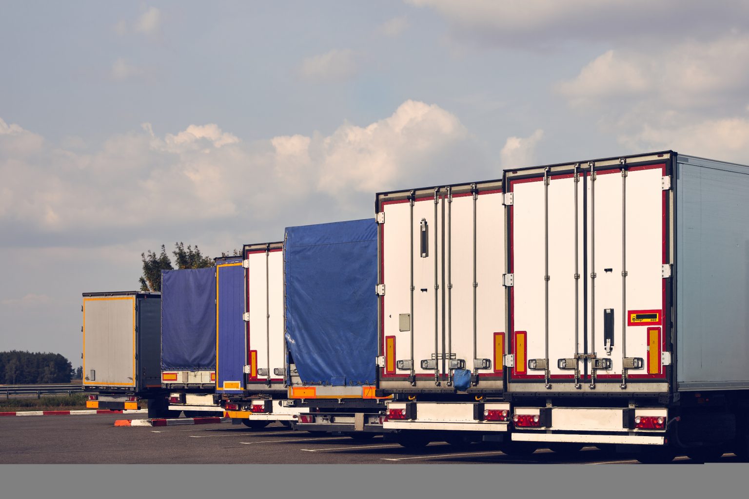 Row of semi trailers parked in a lot
